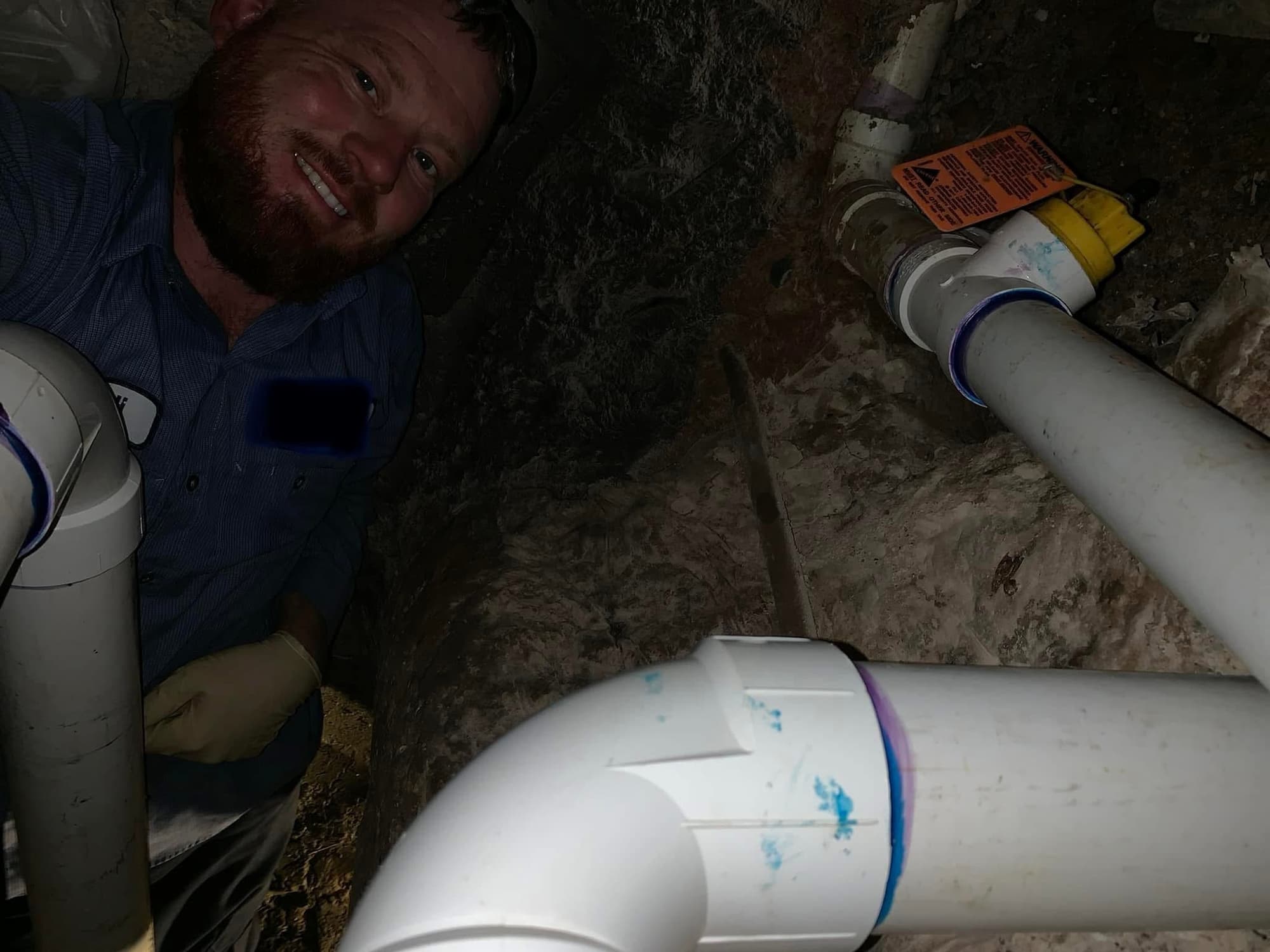 Kodi Wallgren working under a house in Nevada, Texas
